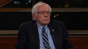 Still from March 3, 2023: Bernie Sanders, John Heiligman, Russell Brand